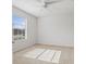 Bright bedroom with carpeted floor, large window, and ceiling fan at 15571 Stone House Dr, Brooksville, FL 34604