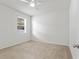 Spacious bedroom with neutral carpeting and large window at 15571 Stone House Dr, Brooksville, FL 34604
