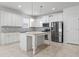 Modern kitchen with a large island and white cabinets at 15571 Stone House Dr, Brooksville, FL 34604