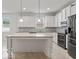 Modern kitchen with granite countertops and stainless steel appliances at 15571 Stone House Dr, Brooksville, FL 34604