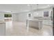 Open concept kitchen with island and white cabinets at 15571 Stone House Dr, Brooksville, FL 34604