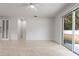 Living room with tile floors, sliding glass doors, and ceiling fan at 15571 Stone House Dr, Brooksville, FL 34604