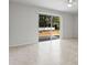 Living area with tile flooring and sliding glass doors to backyard at 15571 Stone House Dr, Brooksville, FL 34604