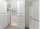 Large walk-in closet featuring custom shelving and drawers at 15571 Stone House Dr, Brooksville, FL 34604