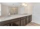Double vanity bathroom with a shower and mirror at 17841 Althea Blue Pl, Lutz, FL 33558