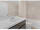 Clean bathroom with a bathtub, shower, and dark vanity at 17841 Althea Blue Pl, Lutz, FL 33558