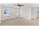 Spacious bedroom with neutral carpeting and ceiling fan at 17841 Althea Blue Pl, Lutz, FL 33558