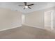 Primary bedroom with carpet, ceiling fan and walk-in closet at 17841 Althea Blue Pl, Lutz, FL 33558