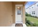 White front door with decorative glass and welcome mat at 17841 Althea Blue Pl, Lutz, FL 33558