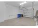 Garage with overhead door and concrete floor at 17841 Althea Blue Pl, Lutz, FL 33558