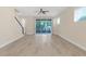 Spacious living area with stairs and sliding glass doors at 17841 Althea Blue Pl, Lutz, FL 33558