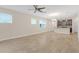 Open living room with tile floors and kitchen island at 17841 Althea Blue Pl, Lutz, FL 33558