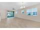 Bright living room featuring sliding glass doors to a screened patio at 17841 Althea Blue Pl, Lutz, FL 33558