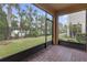 Relaxing screened patio with brick flooring, overlooking a lush green backyard at 17841 Althea Blue Pl, Lutz, FL 33558