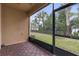 Peaceful screened patio offering a view of the landscaped grounds at 17841 Althea Blue Pl, Lutz, FL 33558