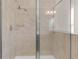 Modern shower with glass enclosure and neutral tile at 17841 Althea Blue Pl, Lutz, FL 33558
