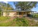 A quaint single-story home with metal roof and simple covered porch at 1802 Mcgee Rd, Plant City, FL 33565