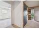 Hallway to bedroom featuring a doorway and another room featuring wood paneling, carpeted floors, and light at 1802 Mcgee Rd, Plant City, FL 33565