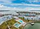Aerial view of waterfront community with pool, shuffleboard, and boat dock at 1868 Shore S Dr # 209, South Pasadena, FL 33707
