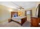 Cozy bedroom with a wooden bed frame and dresser at 1868 Shore S Dr # 209, South Pasadena, FL 33707
