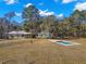 Aerial view of home, pool, and surrounding land at 19256 Hidden Oaks Dr, Brooksville, FL 34604