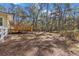 Spacious backyard with wooden deck and surrounding trees at 19256 Hidden Oaks Dr, Brooksville, FL 34604