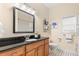 Bathroom with black countertop and updated fixtures at 19256 Hidden Oaks Dr, Brooksville, FL 34604