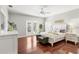Bright bedroom with hardwood floors and access to a private deck at 19256 Hidden Oaks Dr, Brooksville, FL 34604