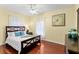 Bright bedroom with a king-size bed, hardwood floors, and natural light at 19256 Hidden Oaks Dr, Brooksville, FL 34604