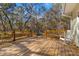 Wooden deck with rocking chair, offering peaceful backyard views at 19256 Hidden Oaks Dr, Brooksville, FL 34604
