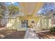 Yellow house exterior with covered walkway and porch at 19256 Hidden Oaks Dr, Brooksville, FL 34604