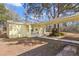 Yellow house exterior with covered walkway and landscaping at 19256 Hidden Oaks Dr, Brooksville, FL 34604