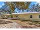 Ranch-style home with metal roof and front porch at 19256 Hidden Oaks Dr, Brooksville, FL 34604