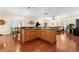 Island kitchen with granite countertops and hardwood floors at 19256 Hidden Oaks Dr, Brooksville, FL 34604
