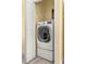 Well-lit laundry room, featuring a washer and dryer at 19256 Hidden Oaks Dr, Brooksville, FL 34604