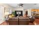Spacious living room with leather furniture, hardwood floors, and built-in shelving at 19256 Hidden Oaks Dr, Brooksville, FL 34604