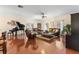 Open living area with hardwood floors, piano, and access to rear deck at 19256 Hidden Oaks Dr, Brooksville, FL 34604