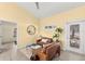 Cozy living room features a comfortable leather sofa and large mirror at 19256 Hidden Oaks Dr, Brooksville, FL 34604