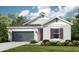 One-story home with gray siding, red shutters, and a two-car garage at 1988 Longliner Loop, Wesley Chapel, FL 33543