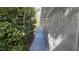 Sidewalk beside house with lush green hedge at 20 Cypress Dr, Palm Harbor, FL 34684