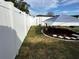 Backyard with white vinyl fence and covered patio at 2152 Arcadia Rd, Holiday, FL 34690