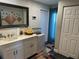 Modern bathroom with double vanity and decorative mirror at 2152 Arcadia Rd, Holiday, FL 34690
