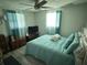 Comfortable bedroom with a queen-size bed and teal bedding at 2152 Arcadia Rd, Holiday, FL 34690
