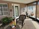 Cozy enclosed porch with rocking chair and potted plants at 2152 Arcadia Rd, Holiday, FL 34690