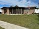 Charming ranch home with a spacious yard and screened porch at 2152 Arcadia Rd, Holiday, FL 34690