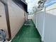 Side yard with artificial turf and AC unit at 2152 Arcadia Rd, Holiday, FL 34690