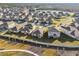 Aerial view of a residential community with houses and a walking path at 22103 Blazing Star Run, Land O Lakes, FL 34637