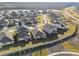 Aerial view of a residential community with houses and a walking path at 22103 Blazing Star Run, Land O Lakes, FL 34637