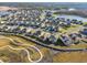 Aerial view of a residential community with many houses and a lake at 22103 Blazing Star Run, Land O Lakes, FL 34637