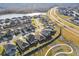 Aerial view of a residential community with houses near a lake at 22103 Blazing Star Run, Land O Lakes, FL 34637